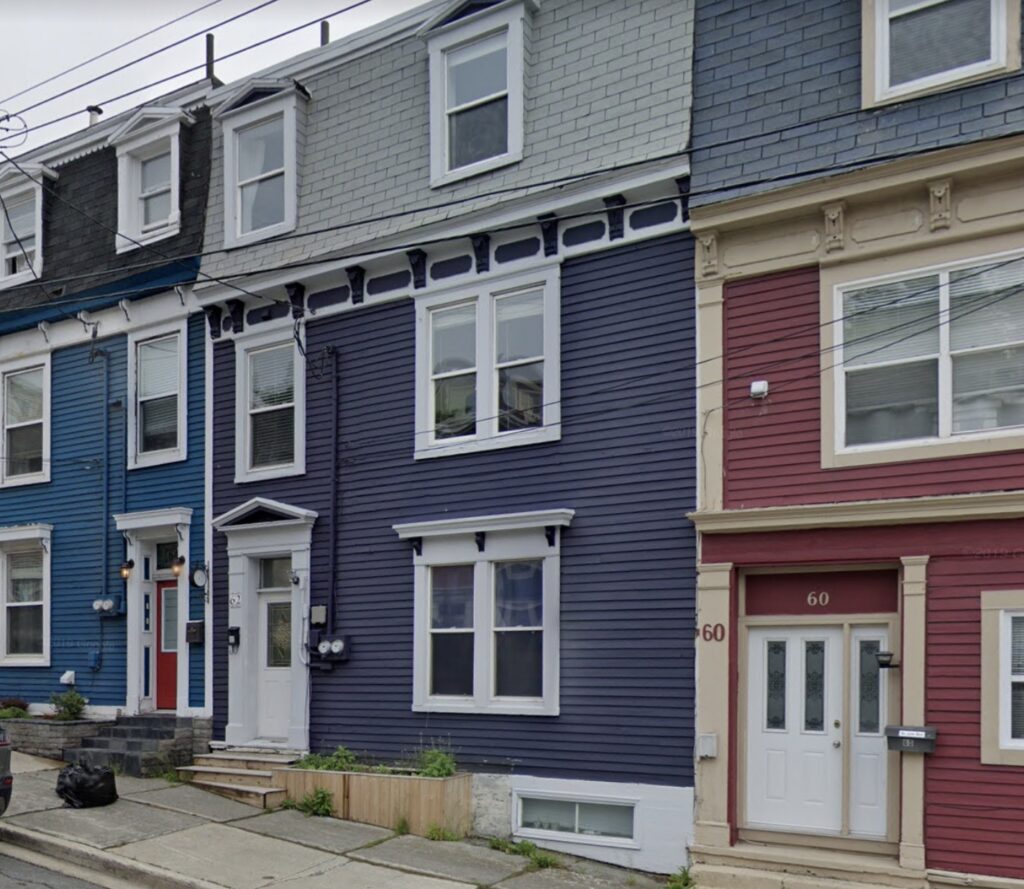 A blue house stands at 62 Prescott Street.